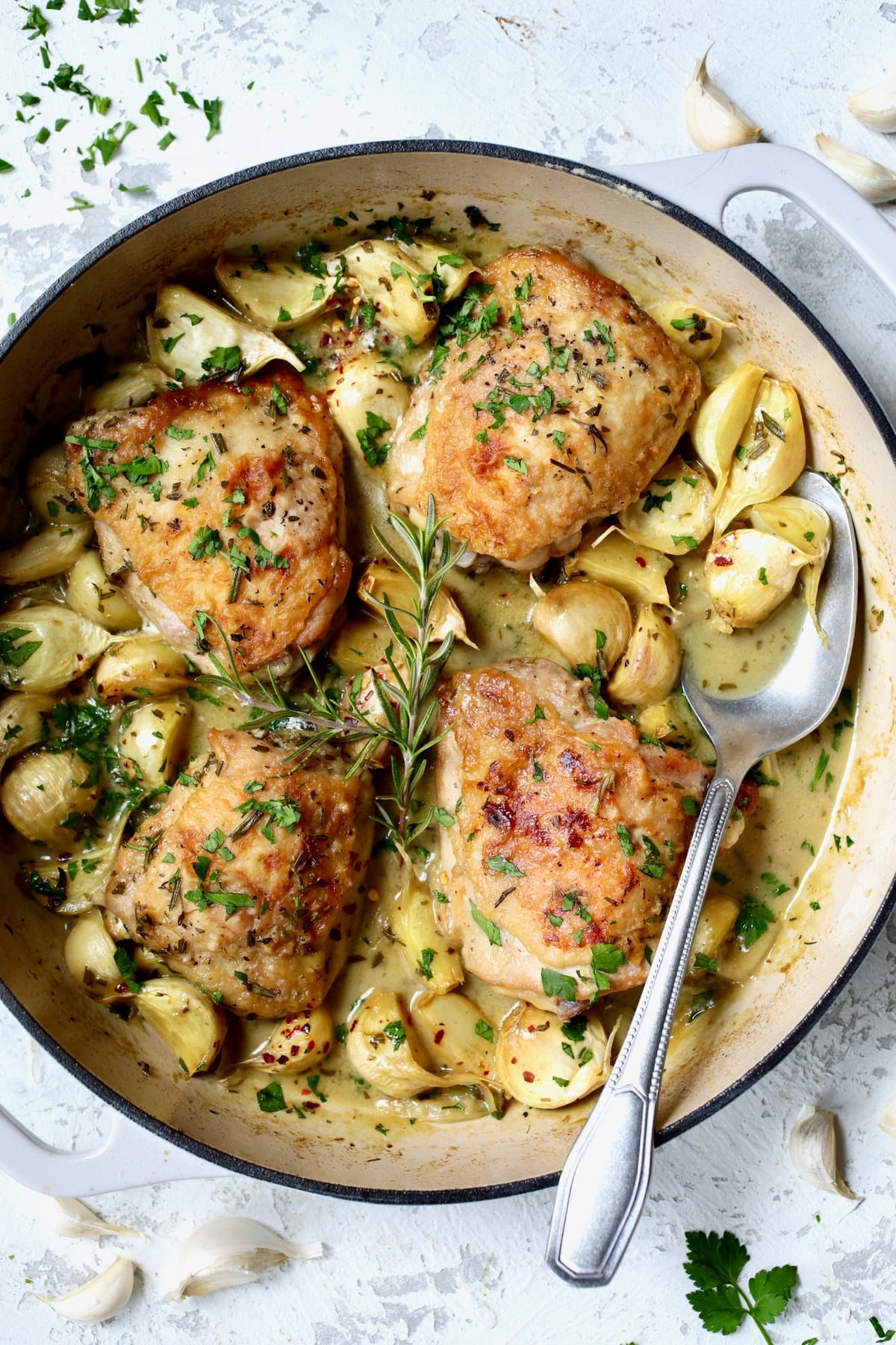 Finished 40 Clove Garlic Chicken in white enamel cast iron skillet.