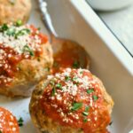 Three Turkey Meatloaf Muffins in white enamel pan.