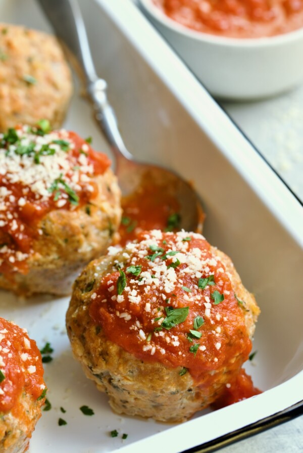 Three Turkey Meatloaf Muffins in white enamel pan.