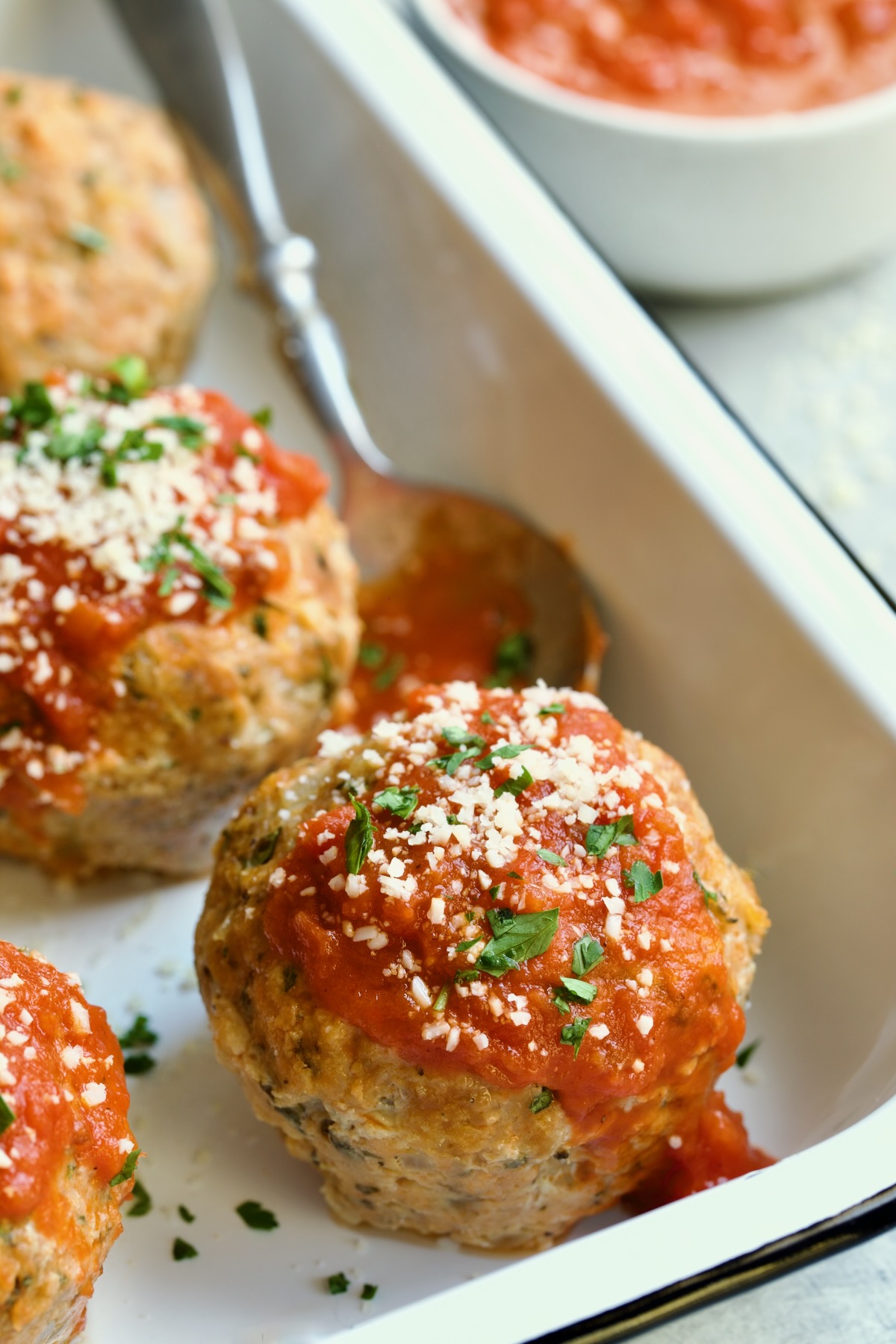 Three Turkey Meatloaf Muffins in white enamel pan.