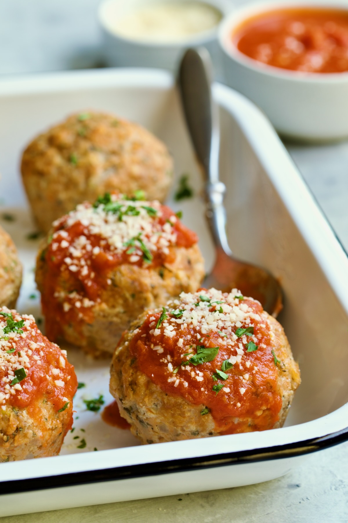 Four Turkey Meatloaf Muffins in white enamel pan.