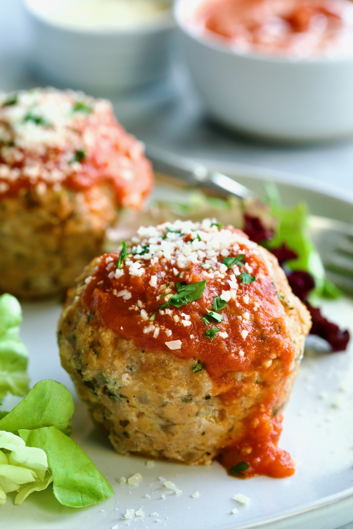 Two Turkey Meatloaf Muffins on white plate.