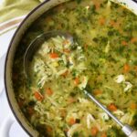Chicken Vegetable Soup with Orzo in white Dutch oven.