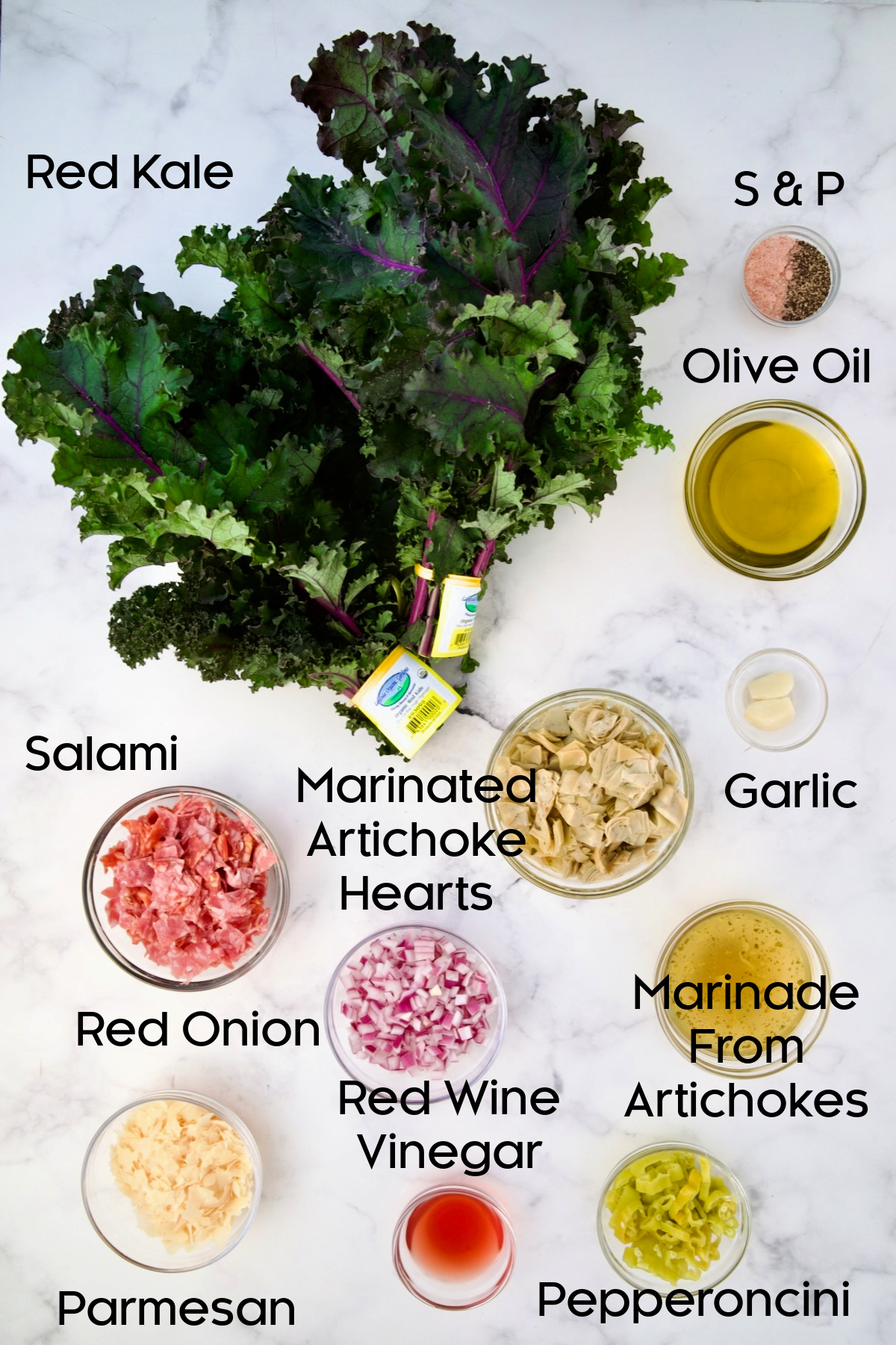 Ingredients for Chopped Kale Salad in glass bowls.