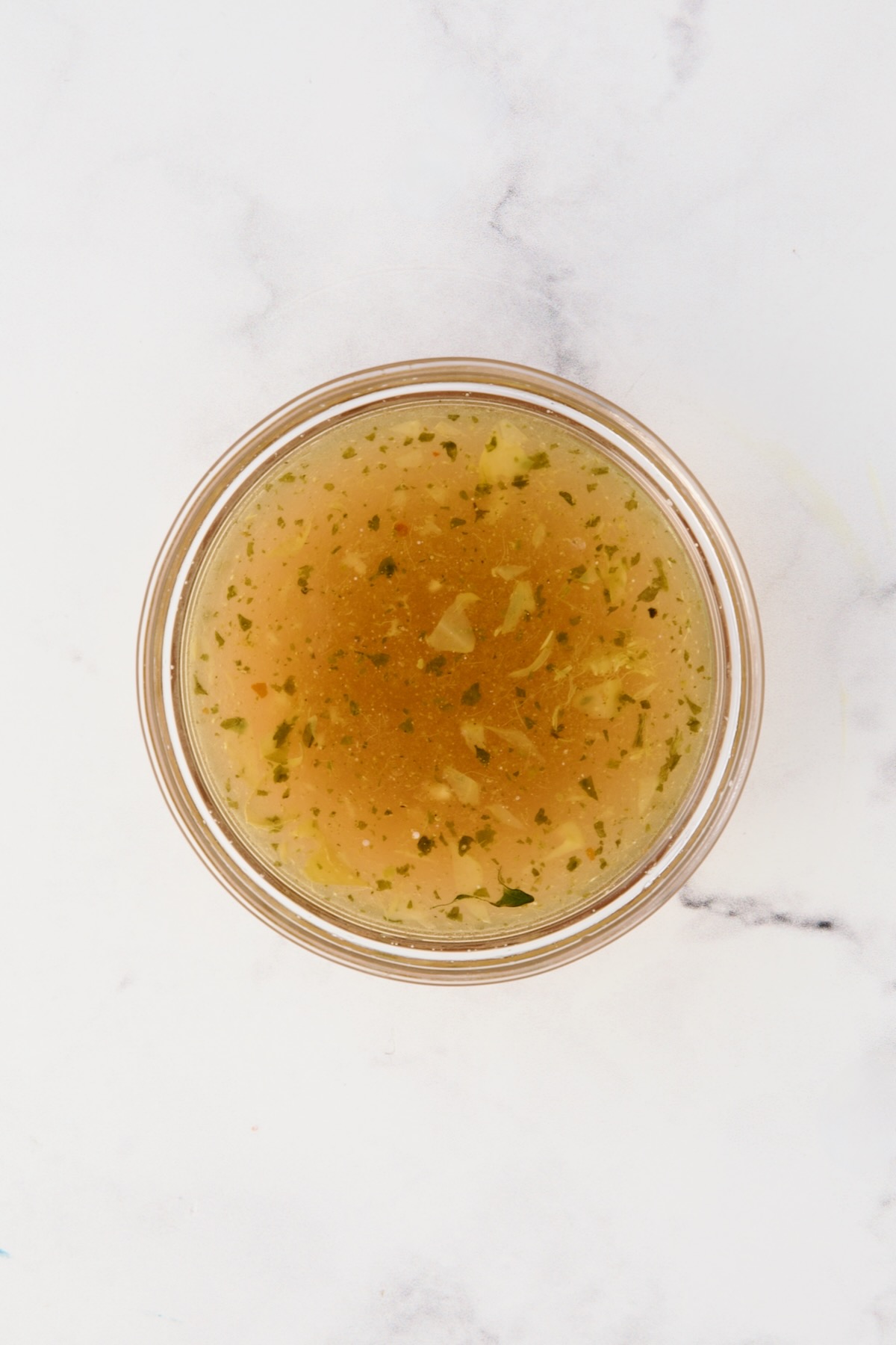 Salad dressing in glass bowl.