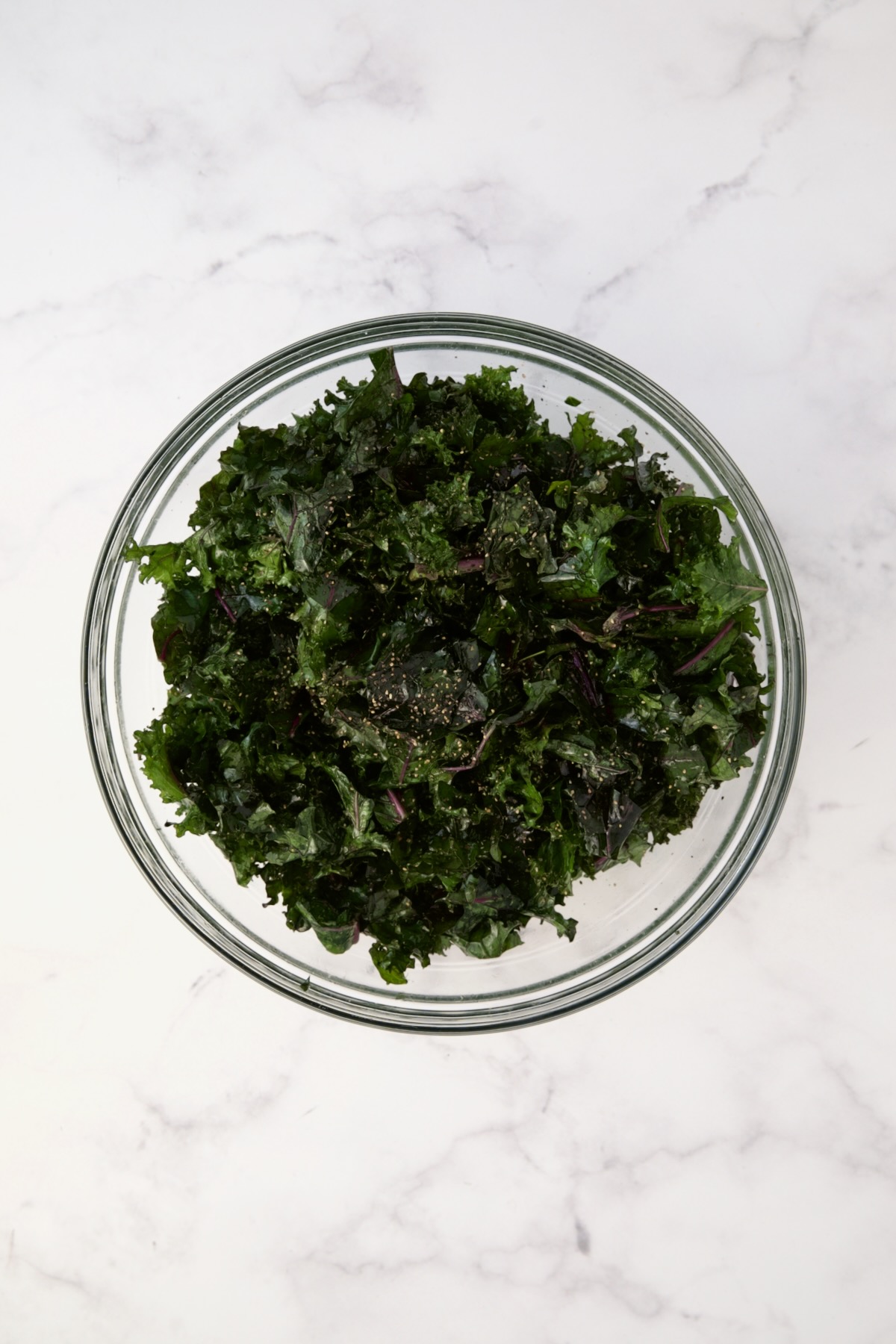 Massaged red kale in glass bowl.
