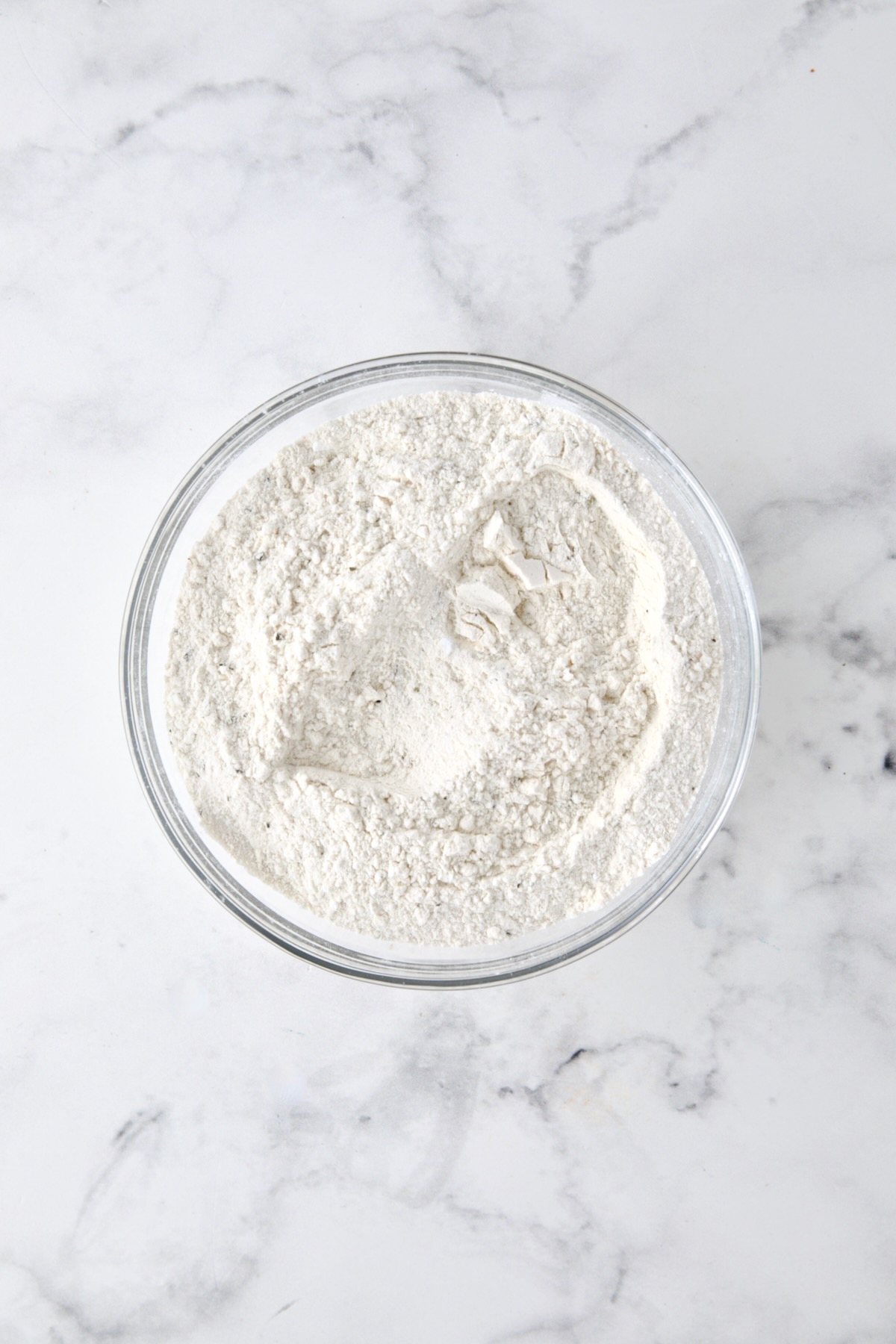 Dry ingredients for bread in glass bowl.
