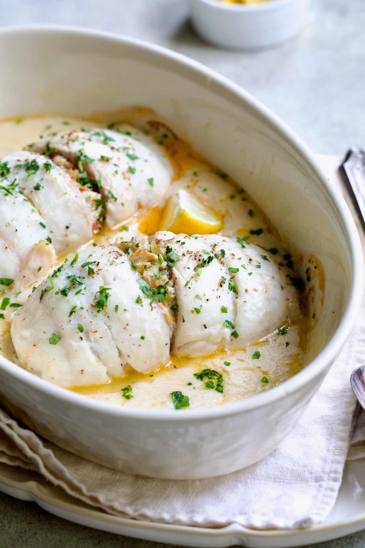Two servings of Crab-Stuffed Flounder in oval baking dish.