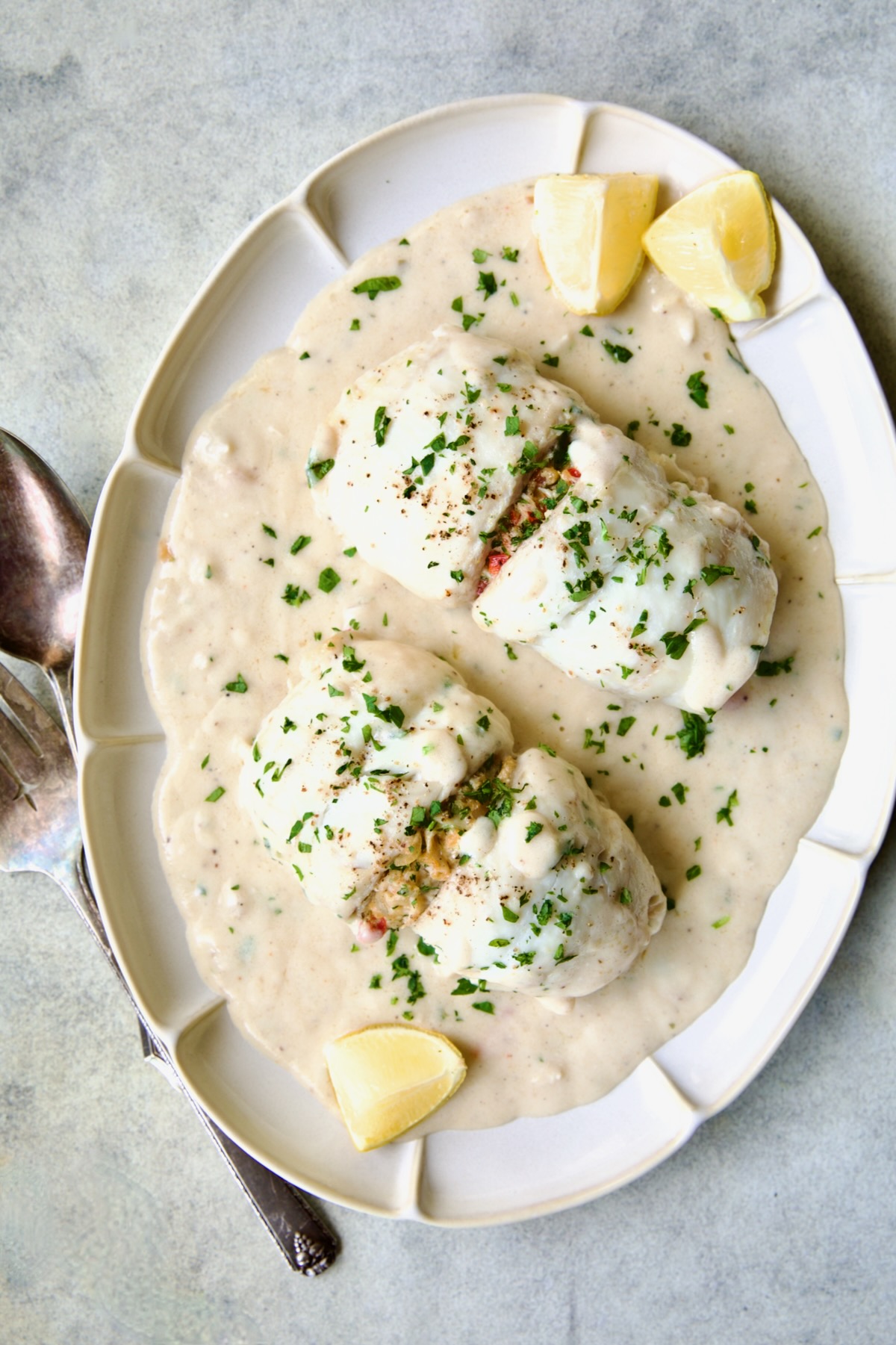 Two servings of Crab-Stuffed Flounder on oval platter with lemon wedges.