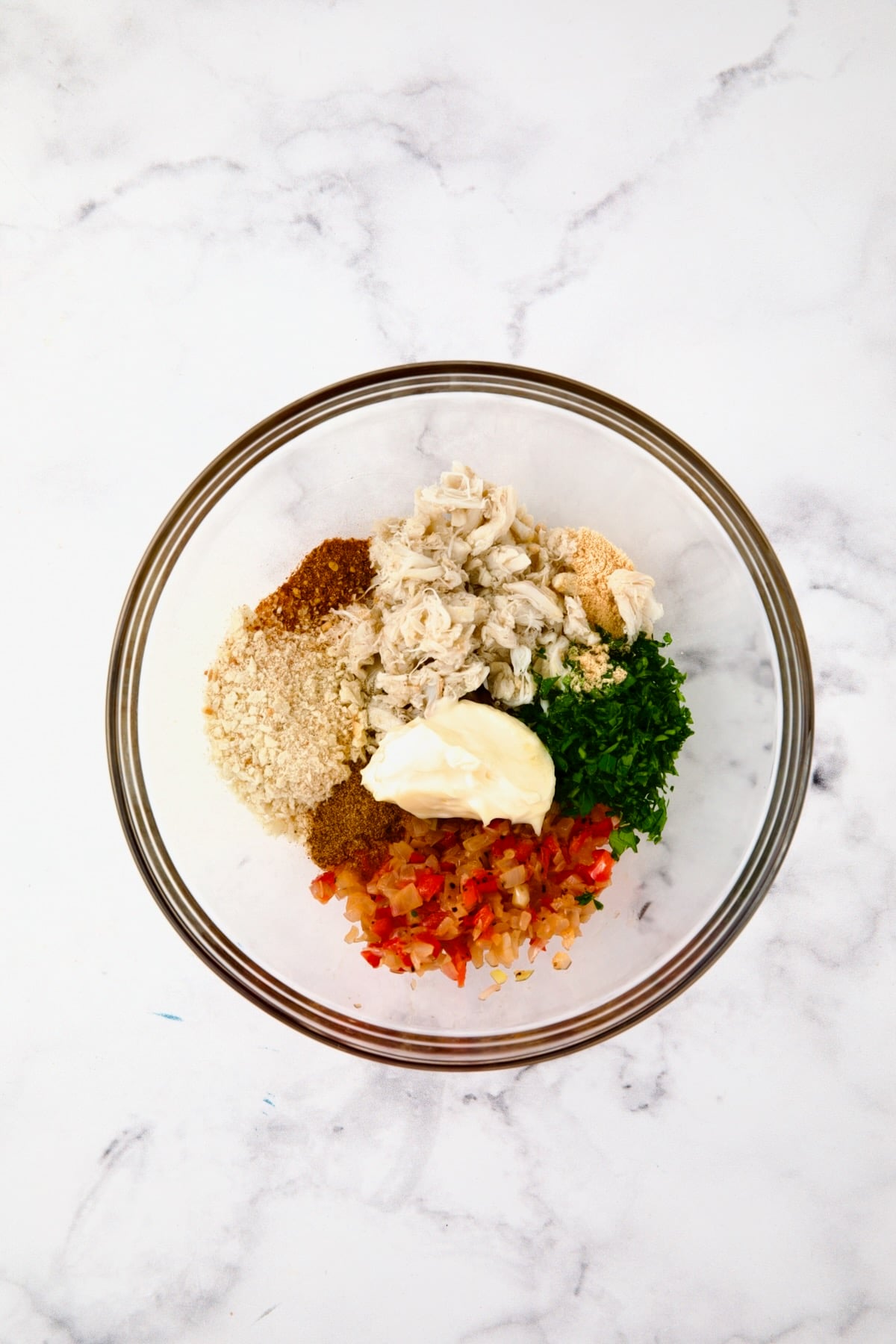 Ingredients for crab filling in glass bowl before being combined.