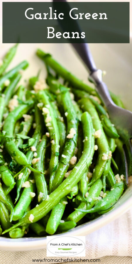 Pinterest graphic for Garlic Green Beans showing them in an oval white bowl with serving fork.