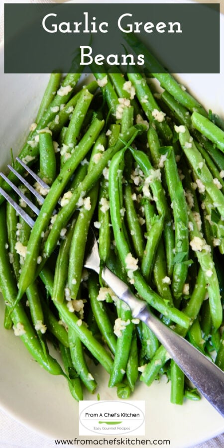 Pinterest graphic for Garlic Green Beans showing them in an oval white bowl with serving fork.