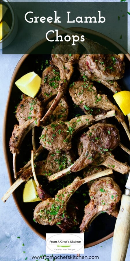 Pinterest graphic for Greek Lamb Chops showing them on a black platter garnished with lemon wedges.