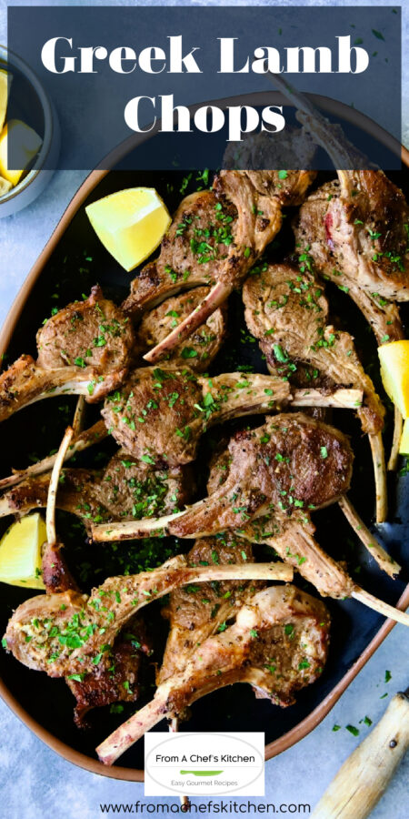 Pinterest graphic for Greek Lamb Chops showing them on a black platter garnished with lemon wedges.