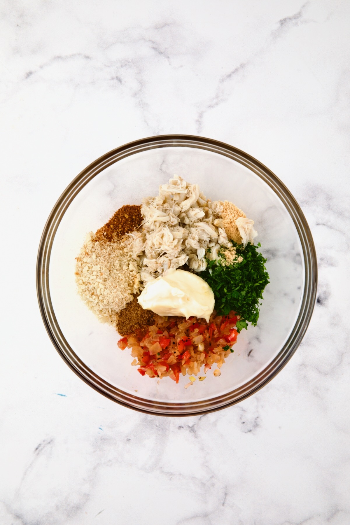 Ingredients for Crab-Stuffed Shrimp in glass bowl being being combined.