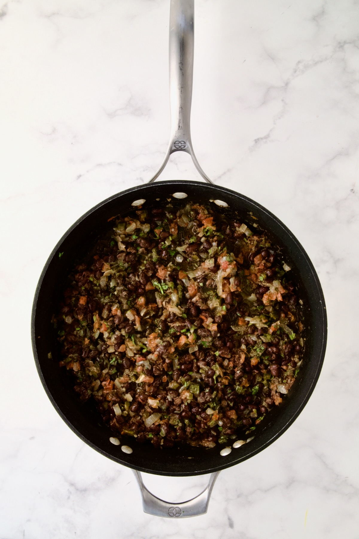 Finished black bean side dish in nonstick skillet.