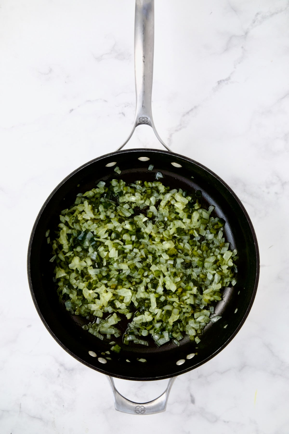 Cooked onion and Poblano peppers in nonstick skillet.
