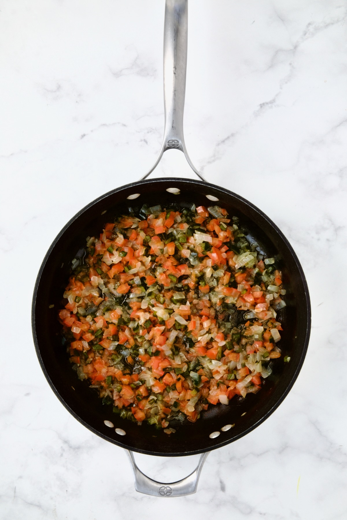 Cooked onion, Poblano and tomatoes in nonstick skillet.