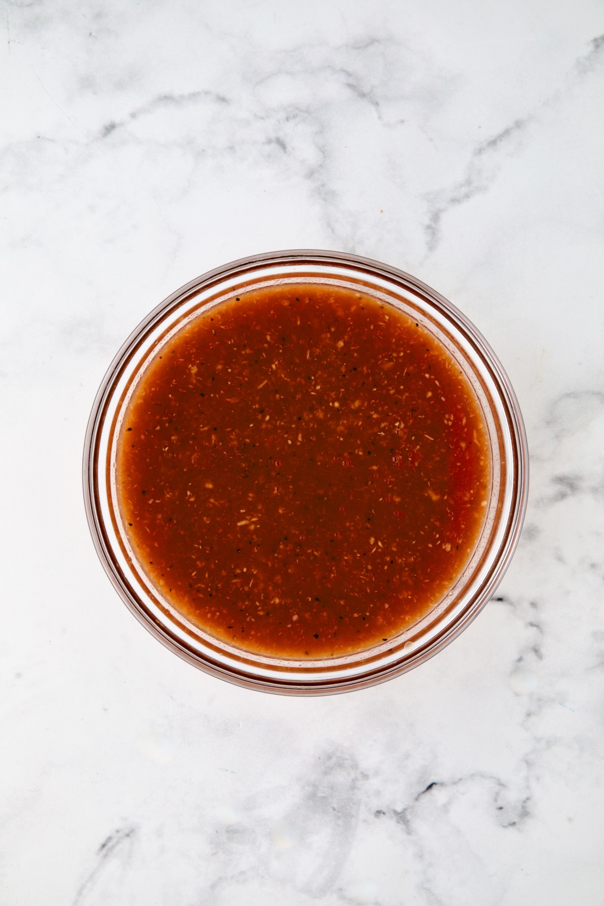 Bloody Mary marinade in glass bowl.