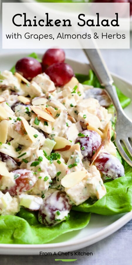 Pinterest graphic for Chicken Salad with Grapes, Almonds and Herbs showing it on a lettuce-lined white plate.