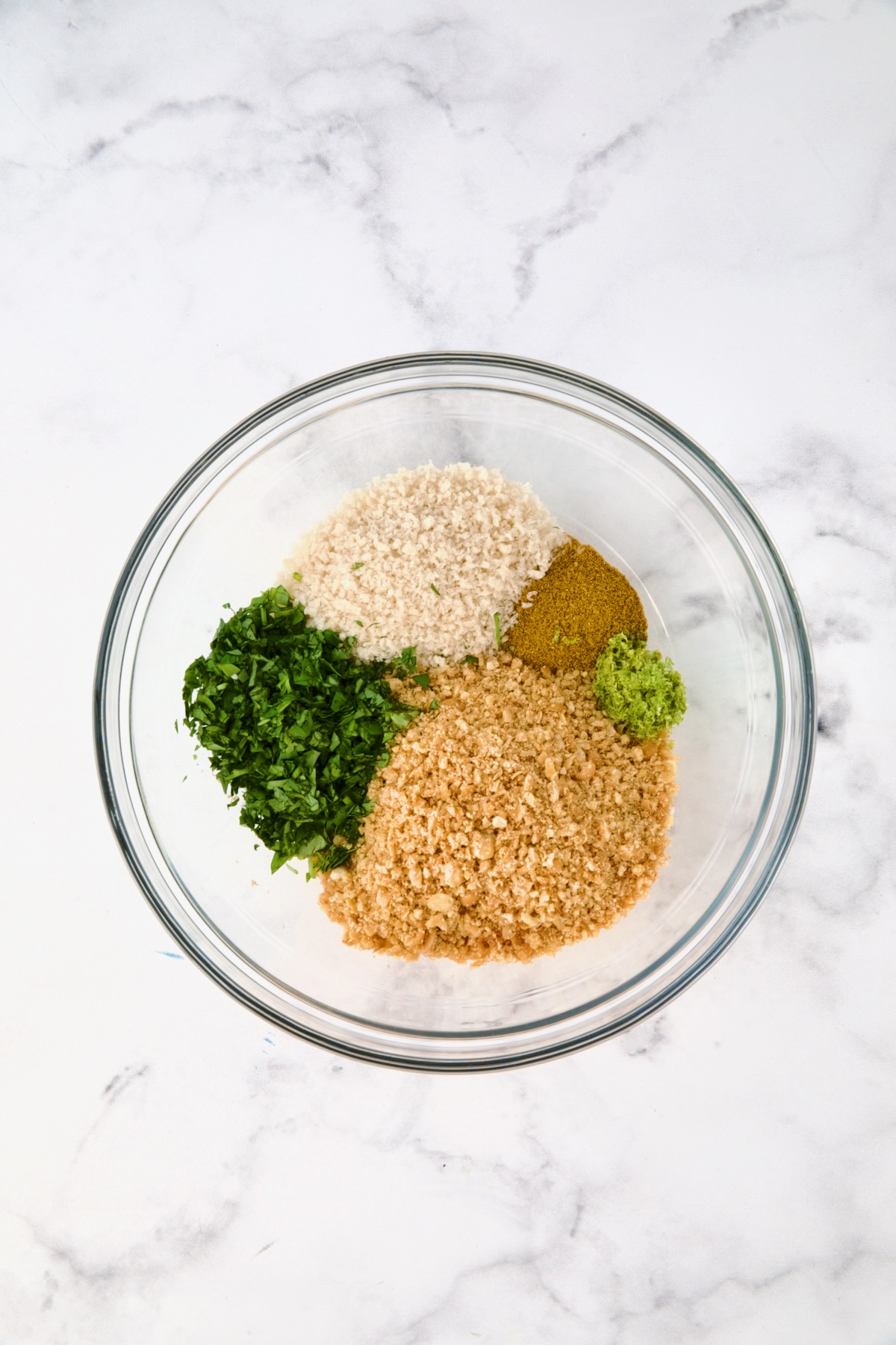 Ingredients for chickpea topping in glass bowl before being combined.