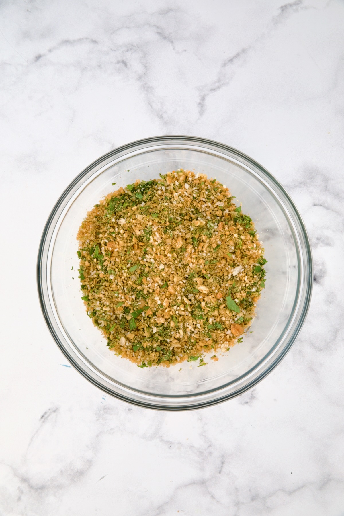 Ingredients for chickpea topping in glass bowl after being combined.