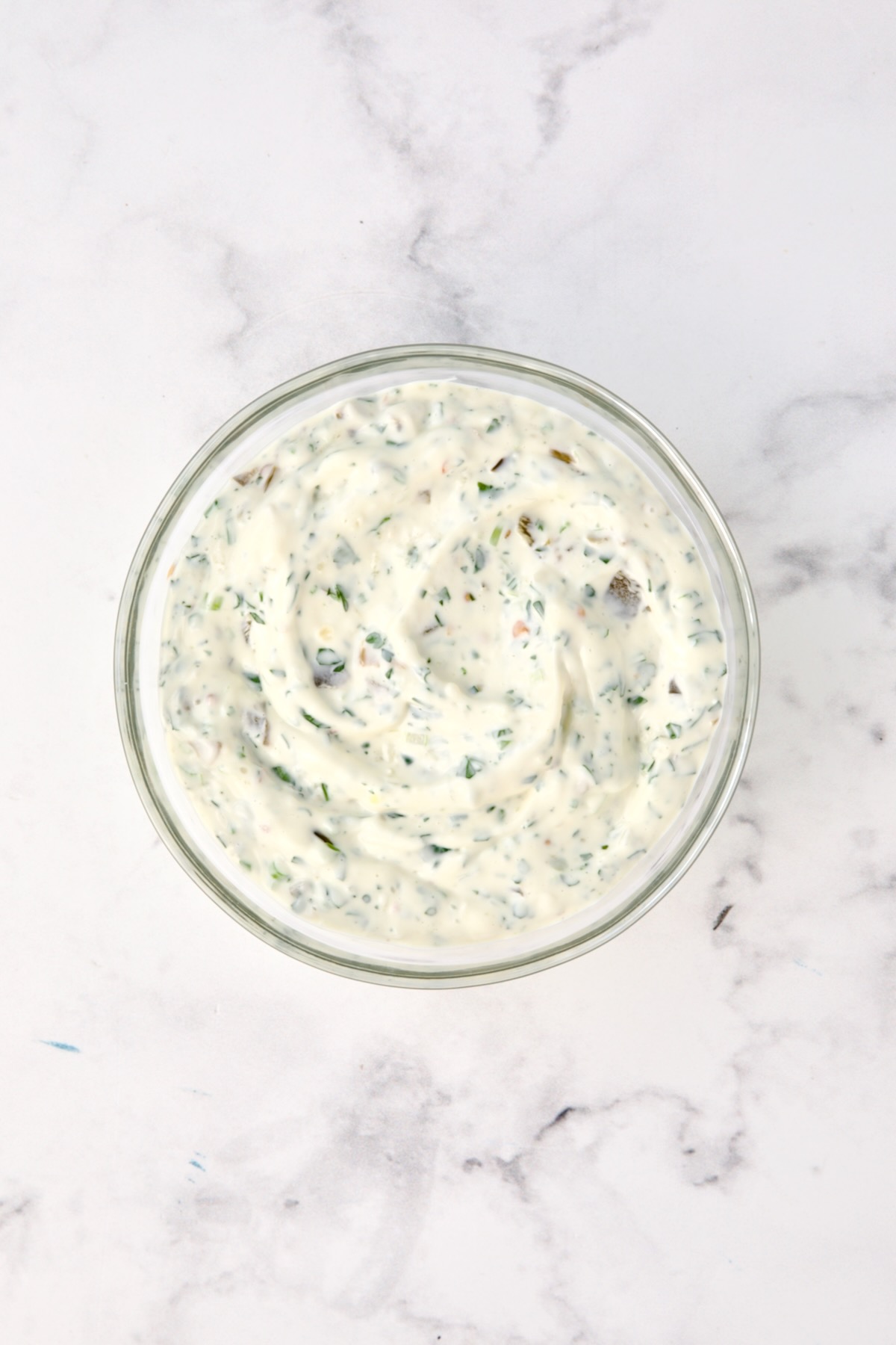 Ingredients for jalapeno tartar sauce in glass bowl.