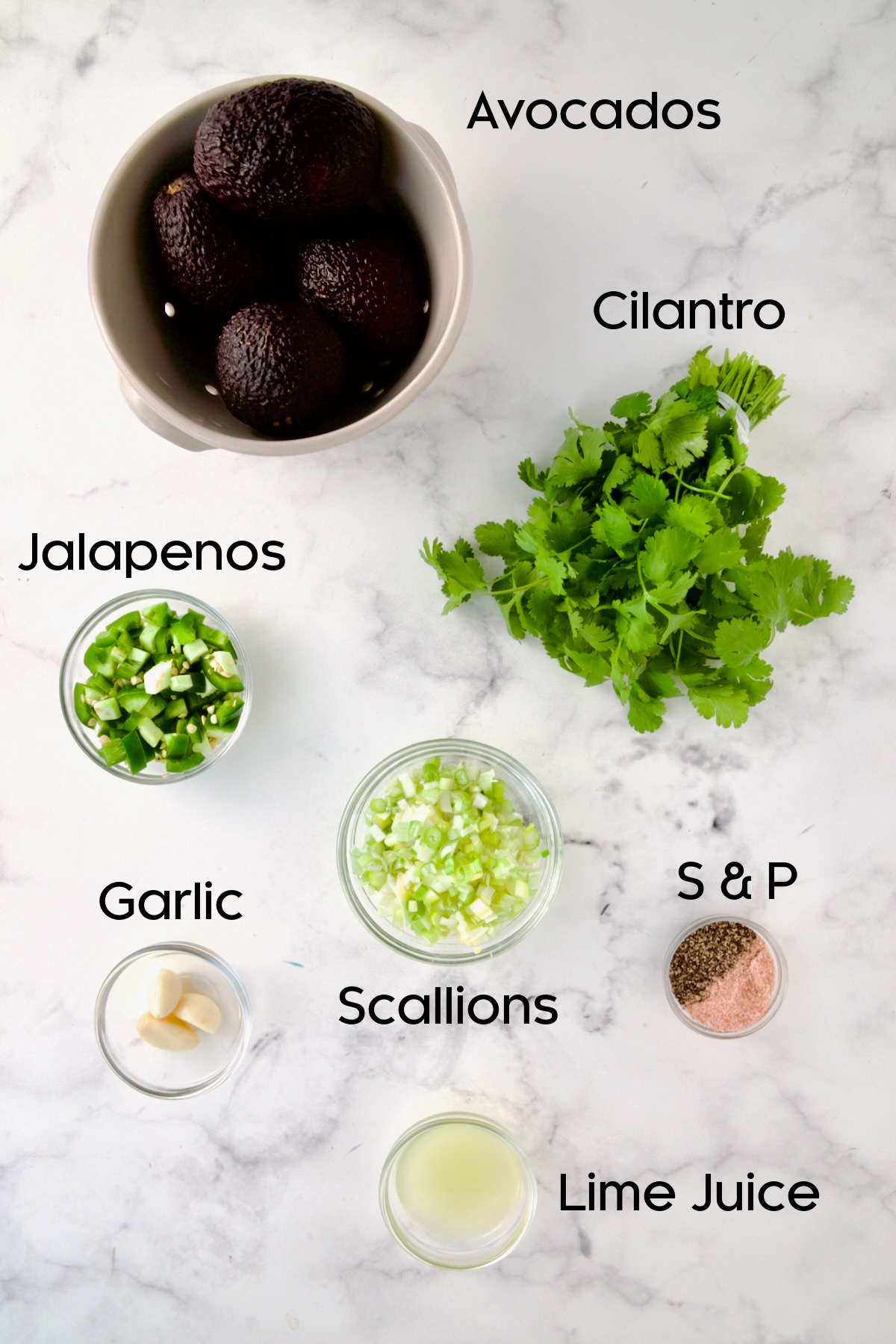 Ingredients for Spicy Guacamole in glass bowls.