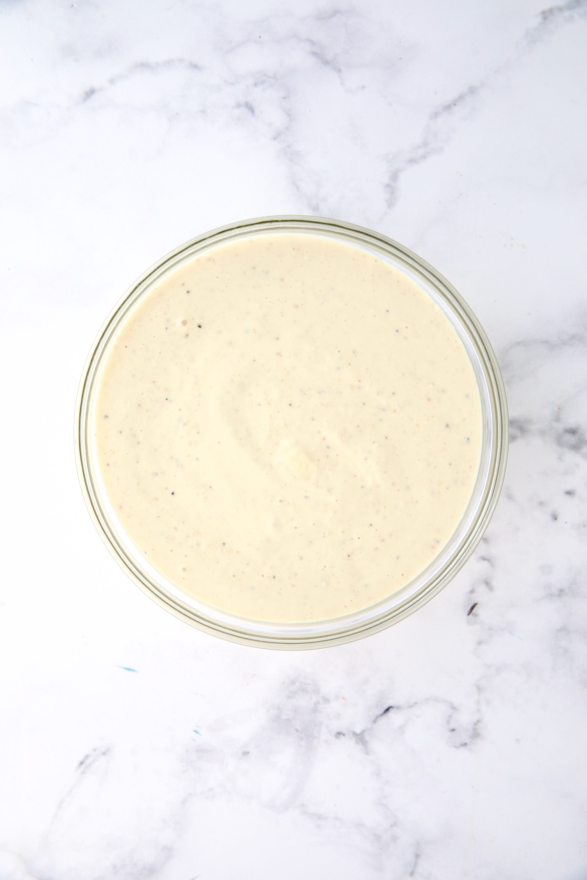Dressing for potato salad in glass bowl.