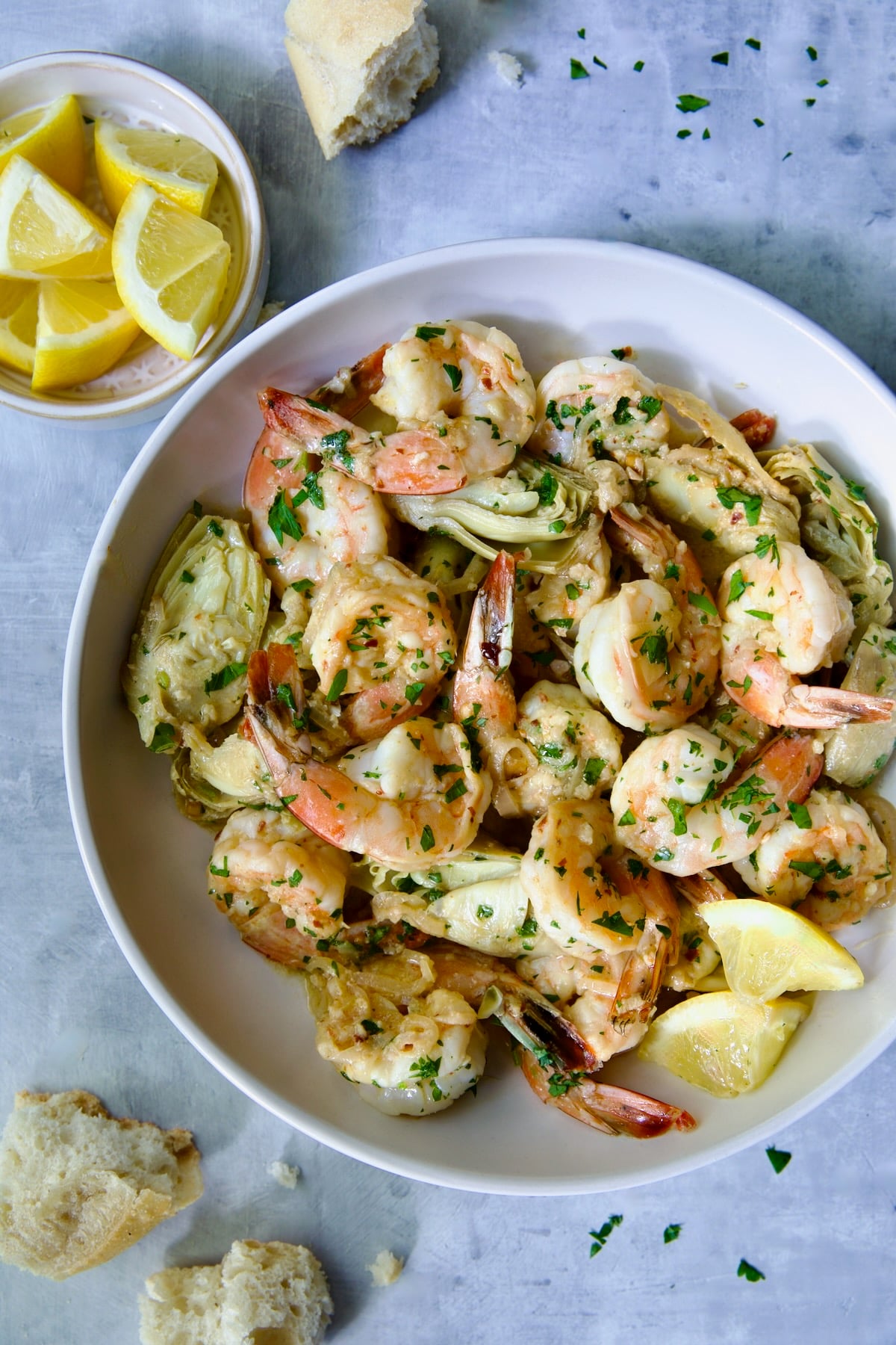 Shrimp Scampi with Artichokes in white bowl.