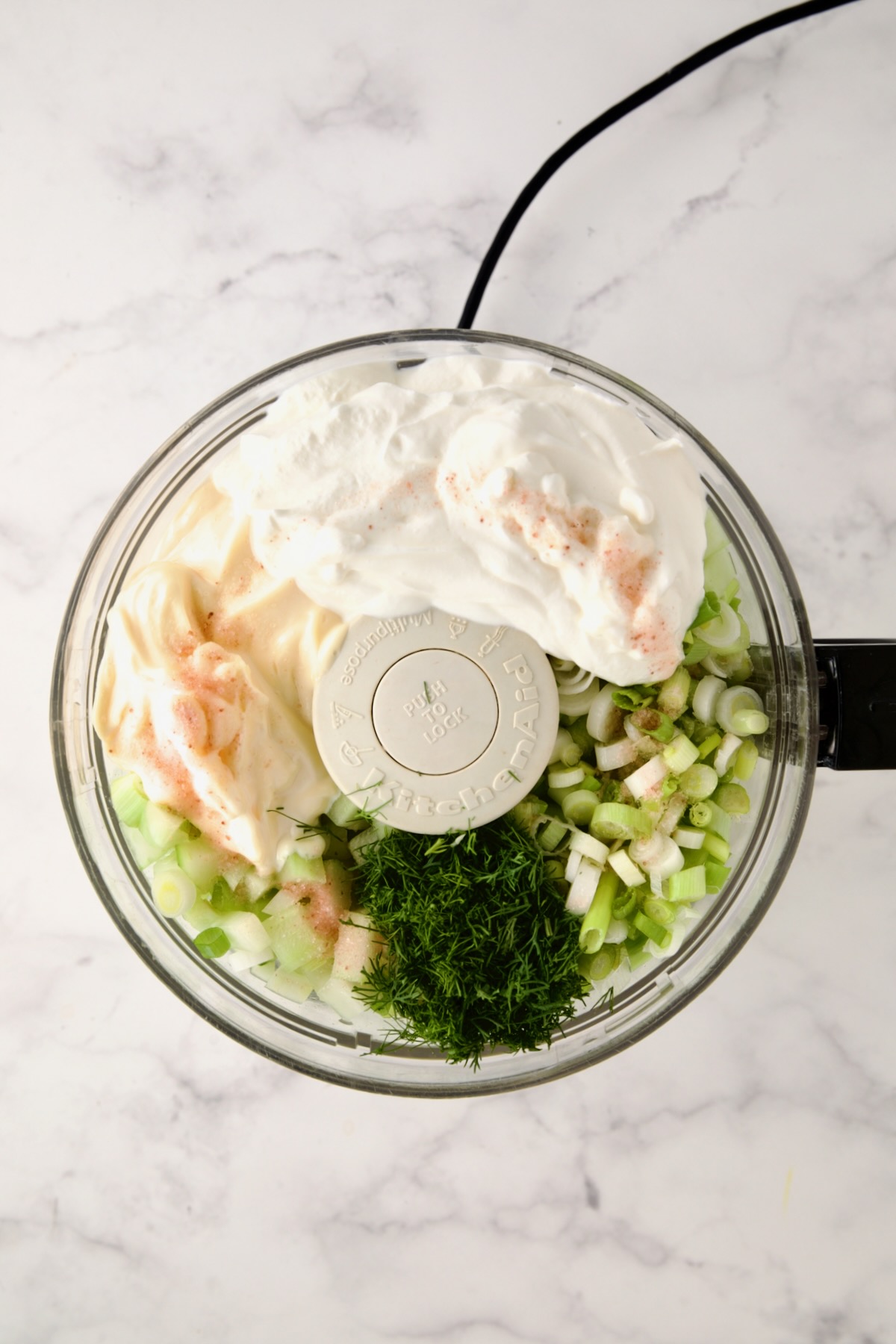 Ingredients for salad dressing in a food processor before being blended together.