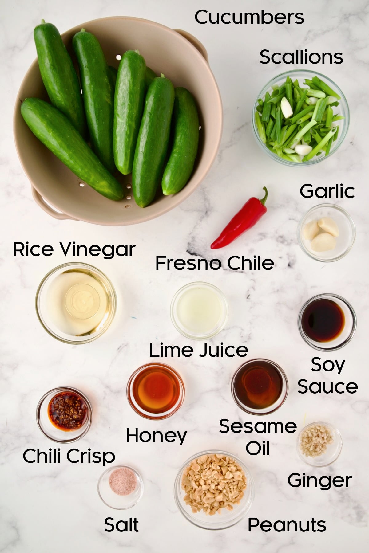 Ingredients for Spicy Asian Cucumber Salad in glass bowls.