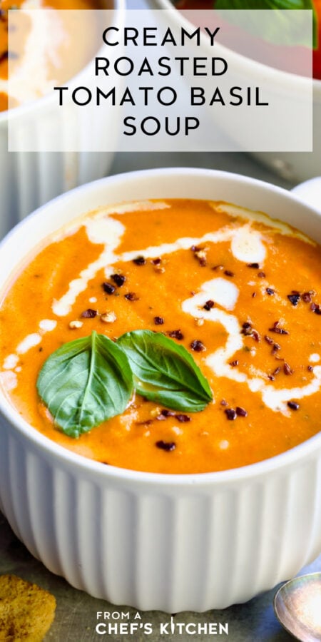 Pinterest graphic for Creamy Tomato and Basil Soup showing it in a white soup mug garnished with fresh basil, cream and red pepper flakes.