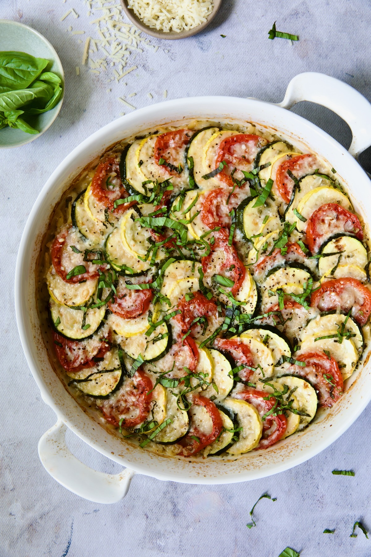 Orzo Vegetable Tian in round white baking dish.
