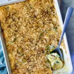 Summer Squash Corn Poblano Casserole in rectangular white baking dish with serving spoon.