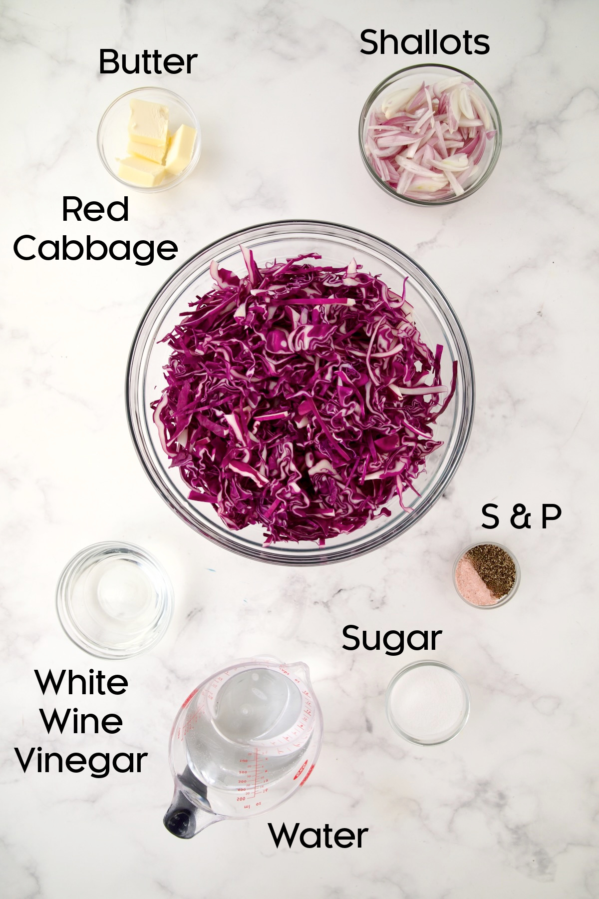 Ingredients for Sweet and Sour Red Cabbage in glass bowls.