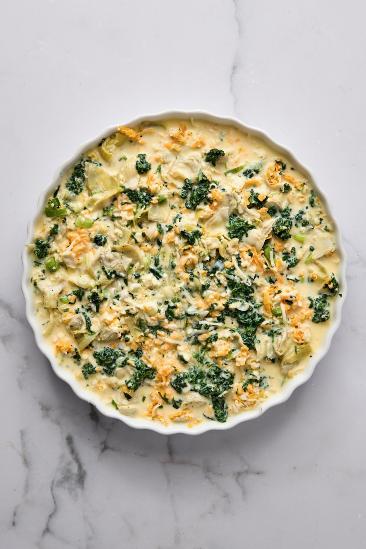 Crustless Spinach Artichoke Quiche before being baked.