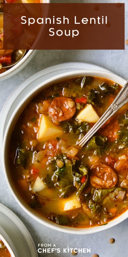 Pinterest graphic for Spanish Lentil Soup showing one serving in a white bowl with soup spoon.