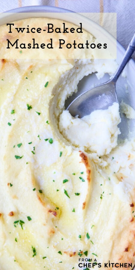 Pinterest graphic for Twice-Baked Mashed Potatoes showing them in an oval baking dish with serving spoon scooping some out.