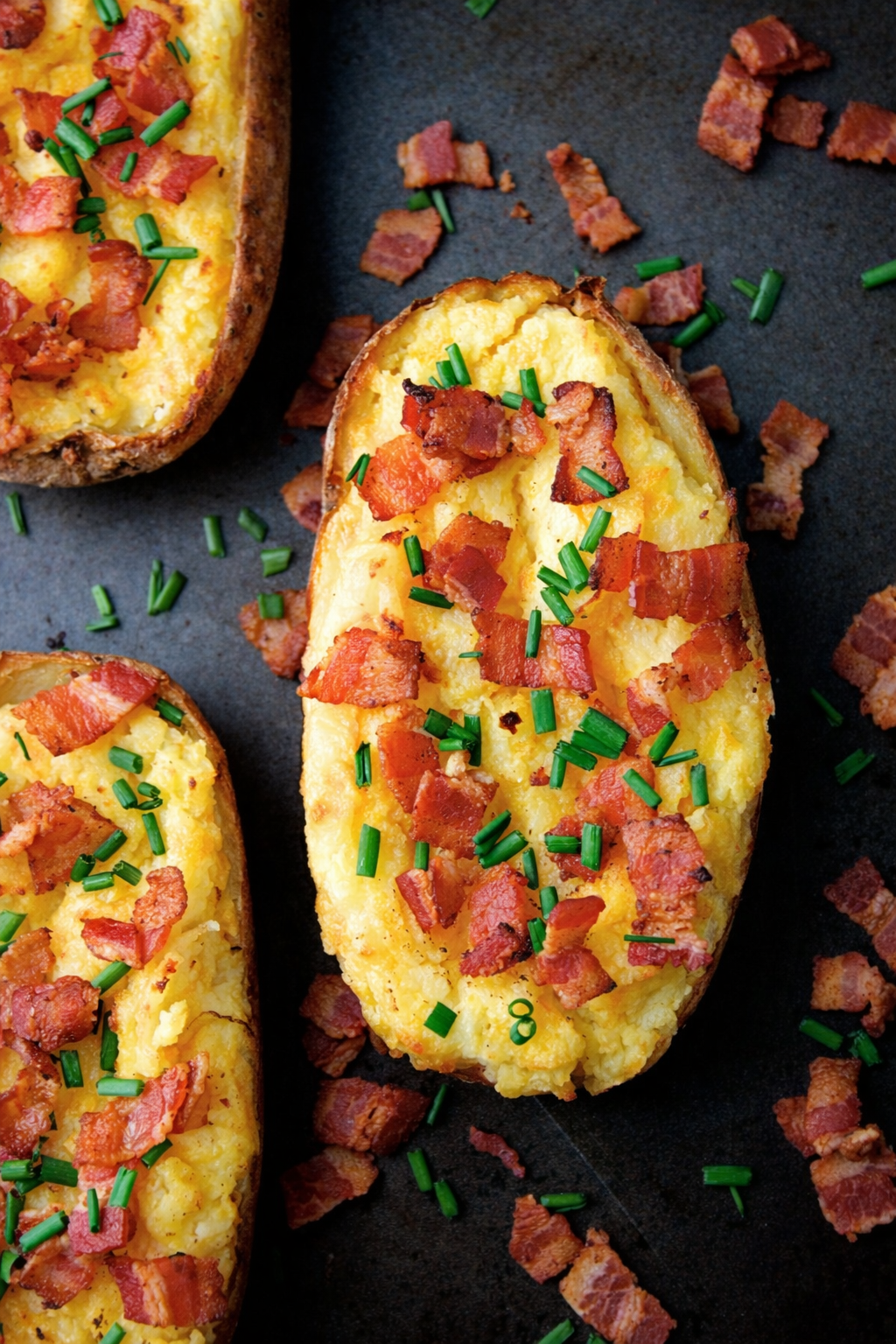 Twice-Baked Potatoes with Cheddar and Bacon on a baking sheet.