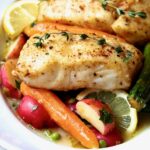 Two servings of Halibut with Braised Lemon Vegetables in white bowl.