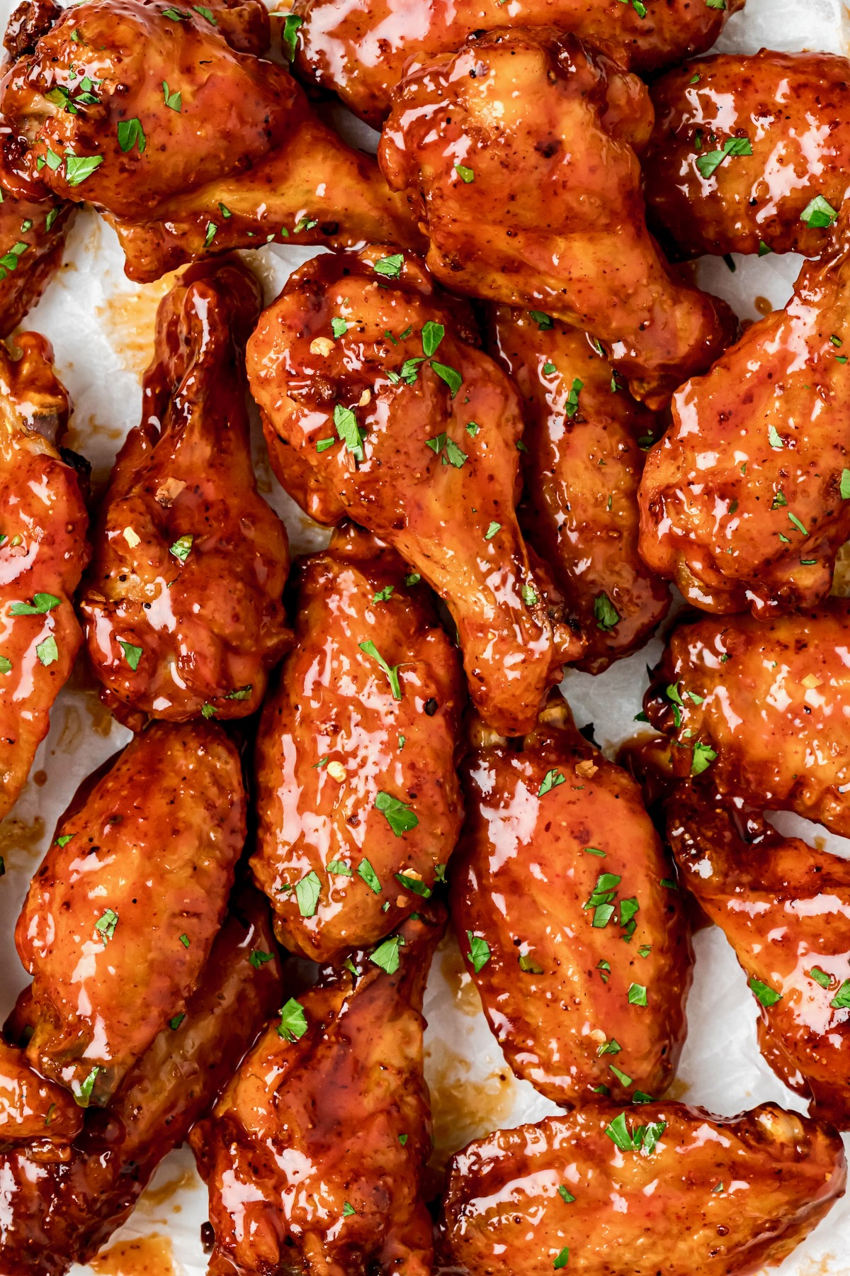 Hot Honey Chicken Wing garnished with chopped parsley.