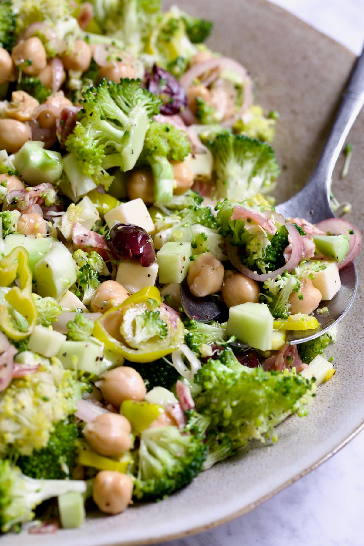Italian Broccoli Salad in earthenware bowl with serving fork.