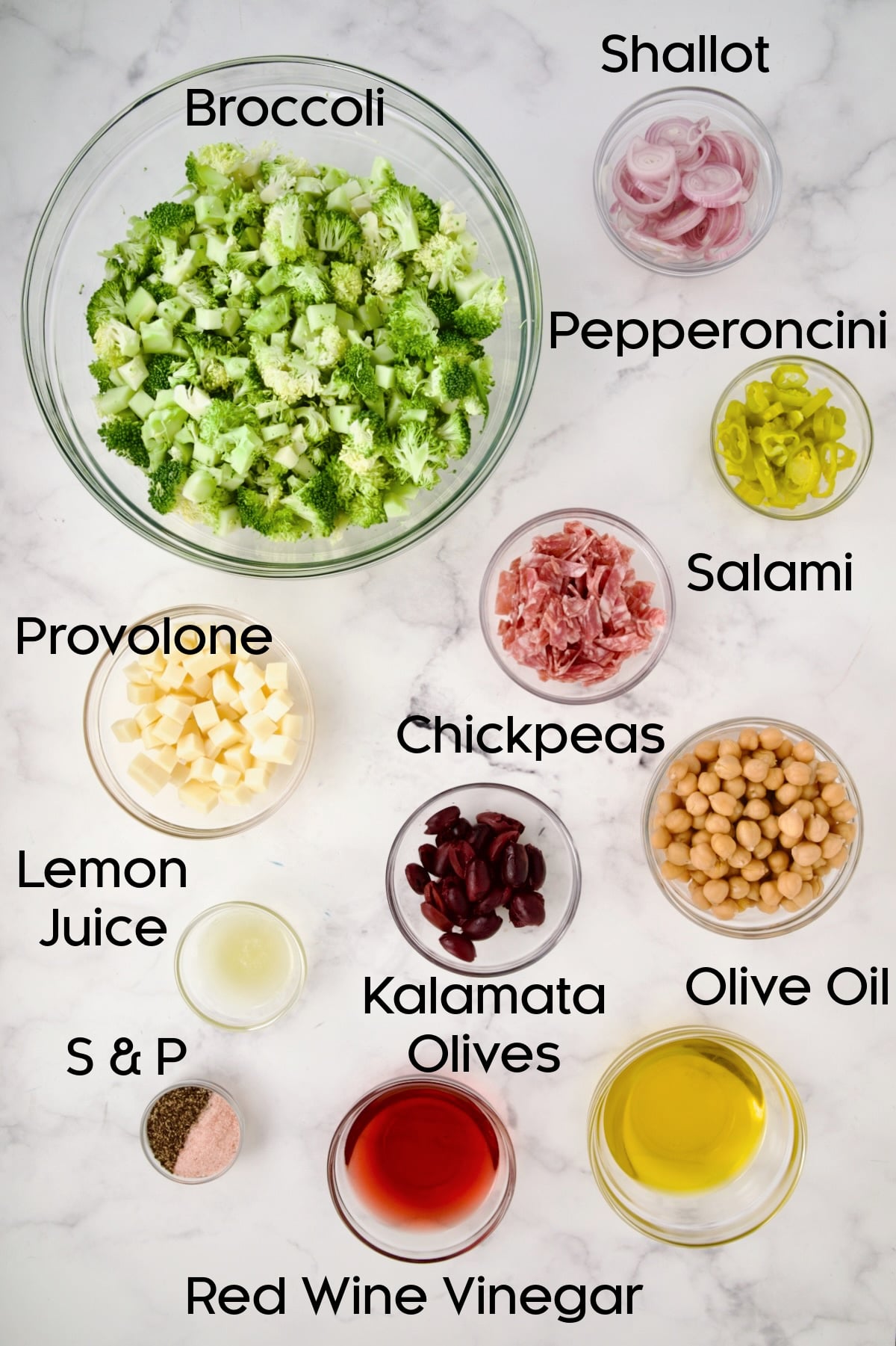 Ingredients for Italian Broccoli Salad in glass bowls.