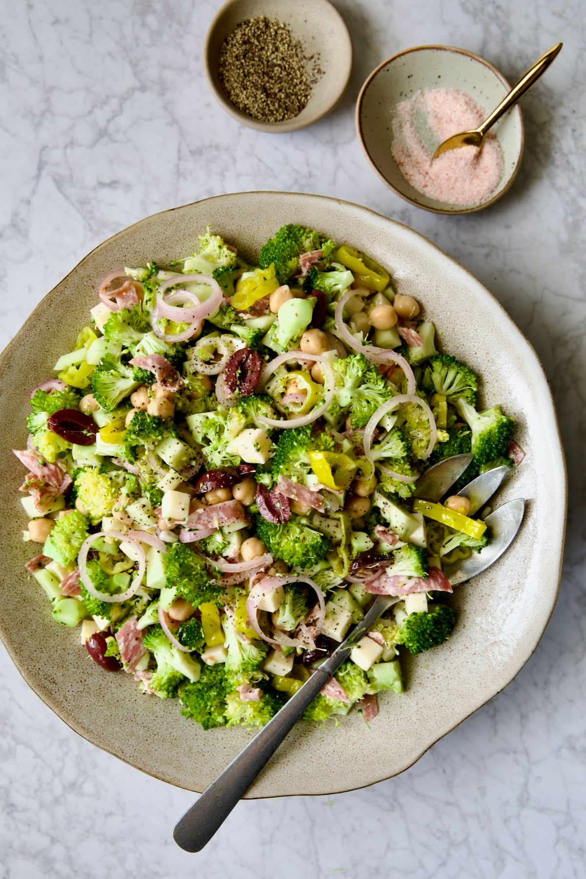 Italian Broccoli Salad in earthenware bowl with serving fork.