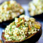 Quinoa Feta and Pistachio Stuffed Acorn Squash on a platter.