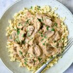 Date Night Beef Stroganoff over curly egg noodles in dinner bowl.