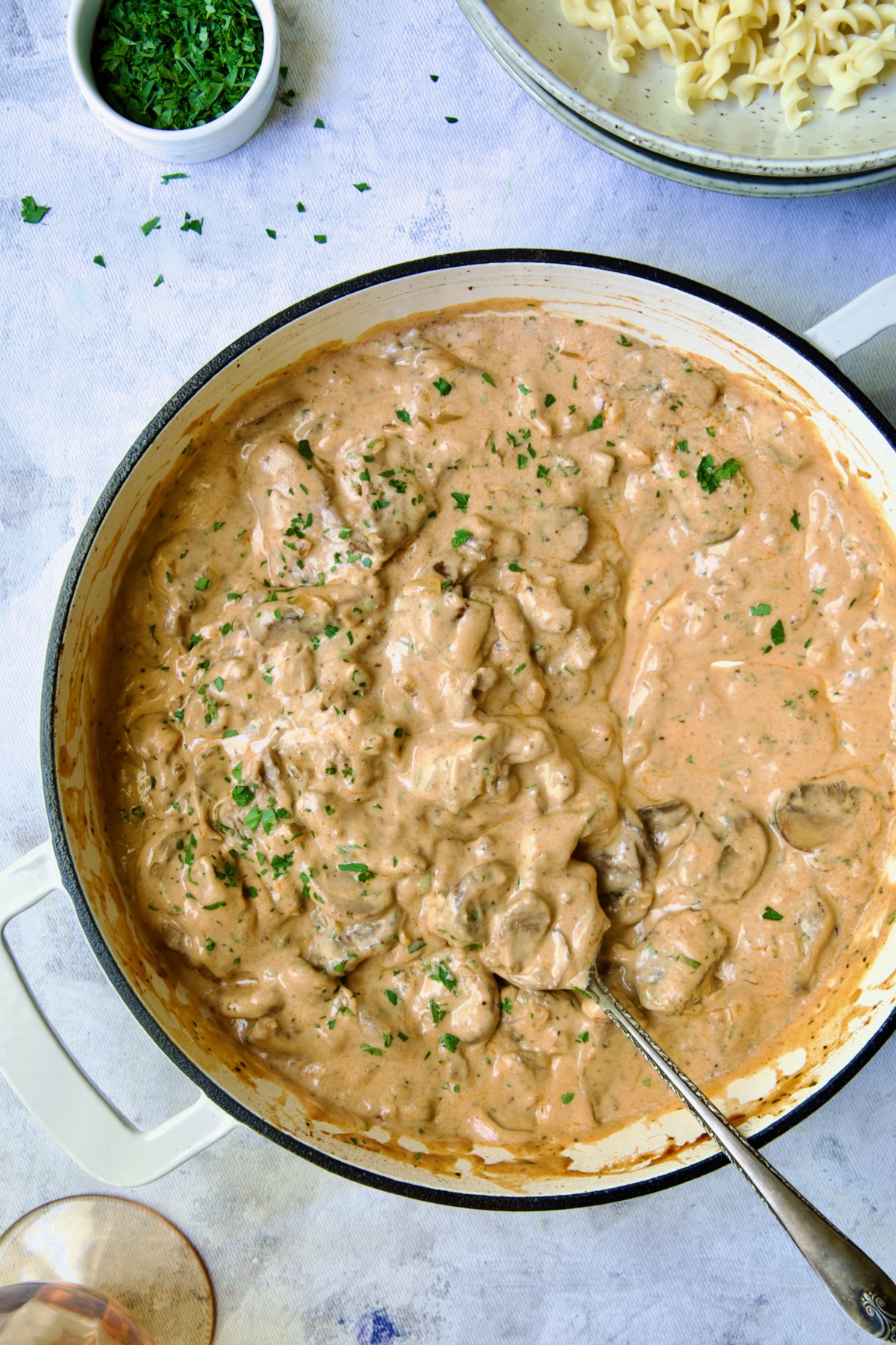 Date Night Beef Stroganoff in white enamel cast iron skillet.