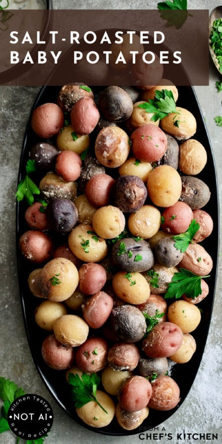 Pinterest graphic for Salt-Roasted Baby Potatoes showing them on an oval black platter.