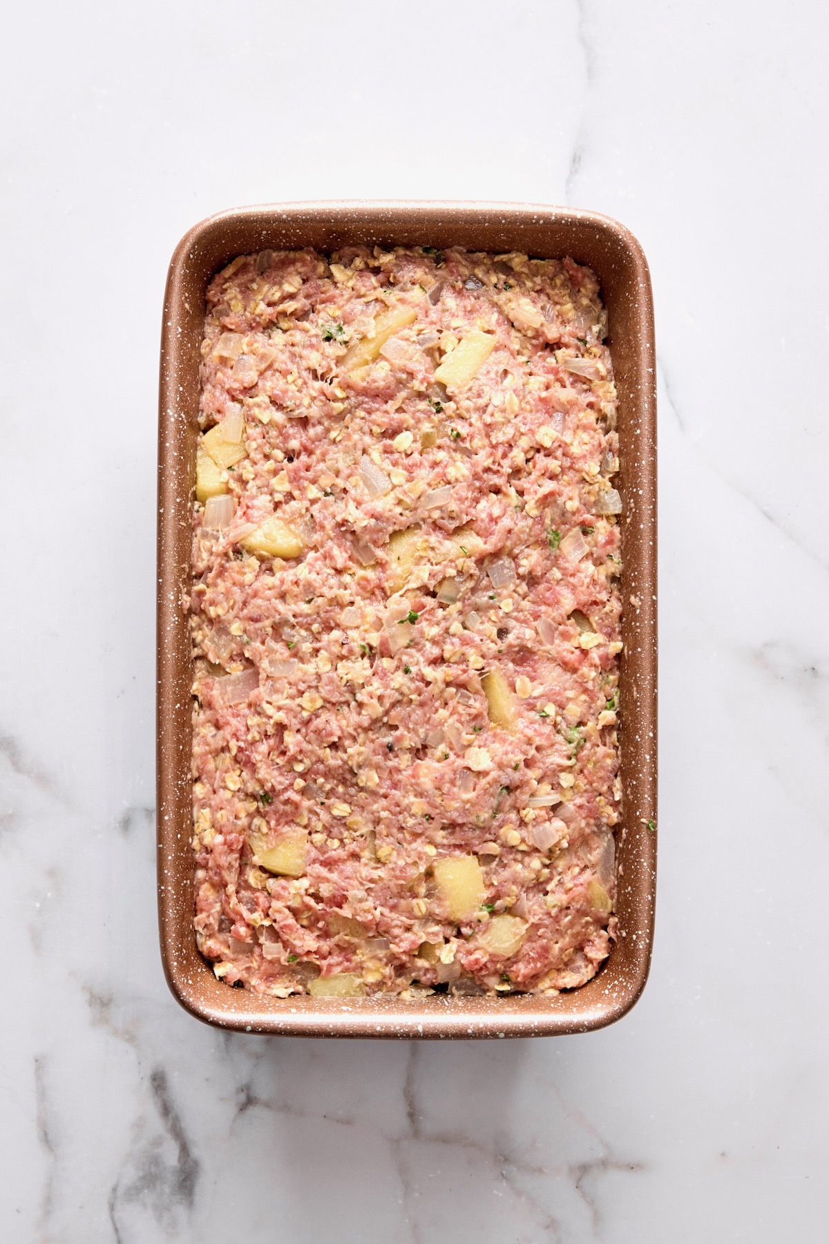 Turkey meatloaf in brown loaf pan.
